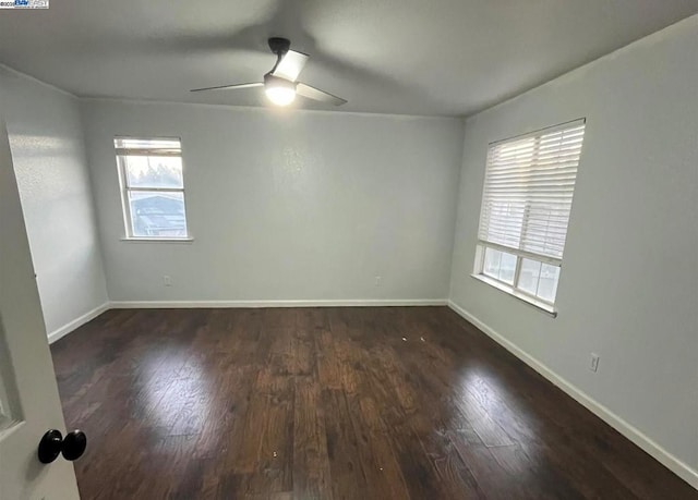 empty room featuring dark hardwood / wood-style floors and ceiling fan