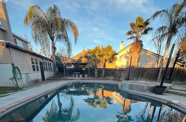 view of pool with a patio area and an in ground hot tub