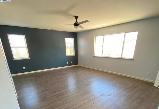 empty room featuring ceiling fan and dark wood-type flooring