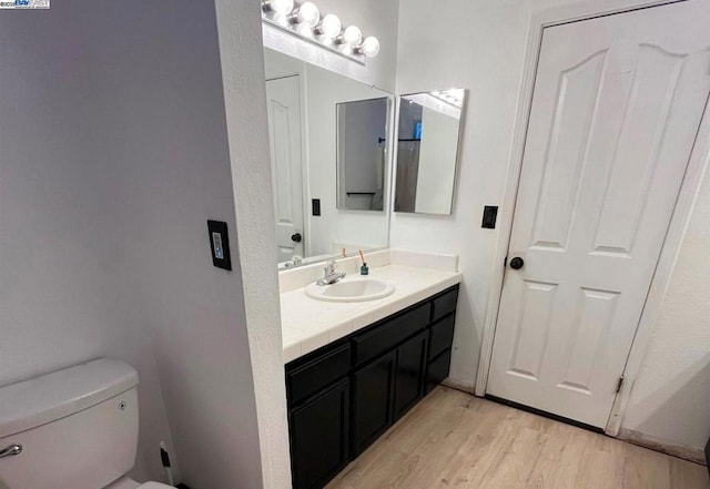 bathroom featuring vanity, toilet, and wood-type flooring