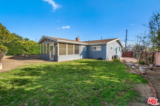 back of house featuring a yard, central AC, and a sunroom