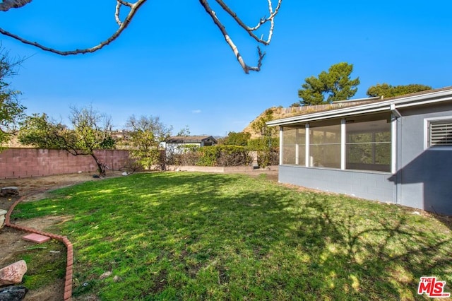 view of yard featuring a sunroom