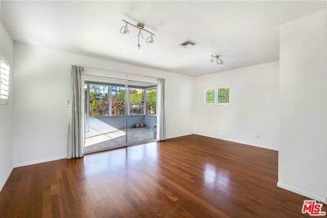 spare room featuring dark hardwood / wood-style floors