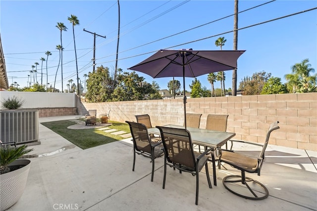 view of patio featuring an outdoor fire pit and central AC