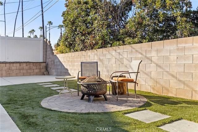 view of yard with an outdoor fire pit and a patio