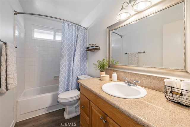 full bathroom featuring toilet, shower / bath combo with shower curtain, wood-type flooring, and vanity