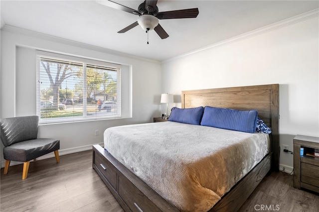 bedroom with ceiling fan, crown molding, and hardwood / wood-style flooring