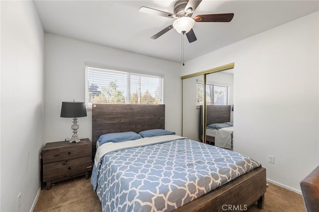 bedroom featuring ceiling fan, light colored carpet, and a closet