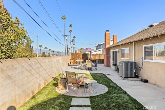 view of yard featuring a patio area and central AC