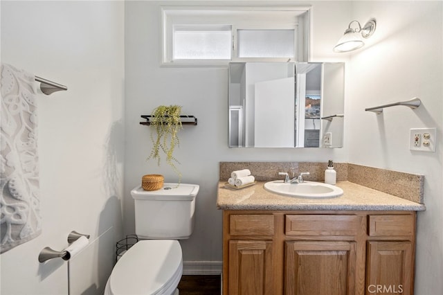 bathroom with toilet and vanity