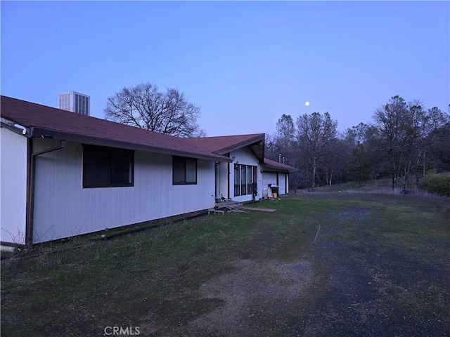view of home's exterior featuring cooling unit and a lawn