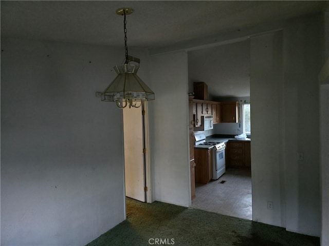 kitchen with decorative light fixtures, white range with gas cooktop, and light colored carpet