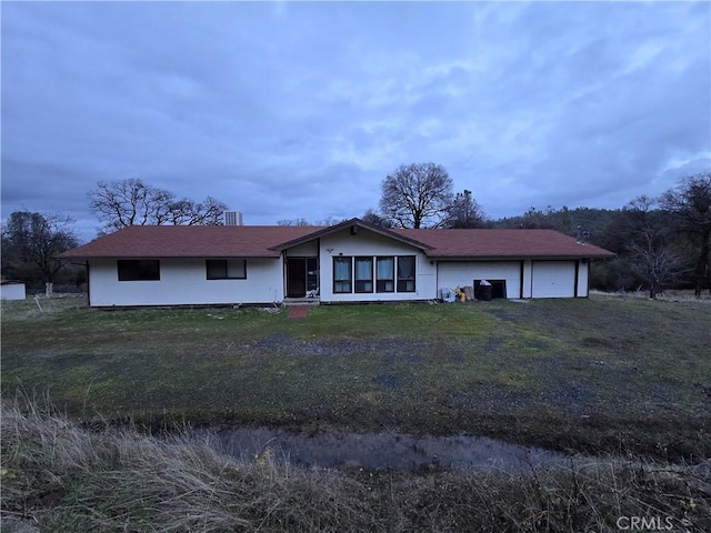 ranch-style house with a front lawn and a garage