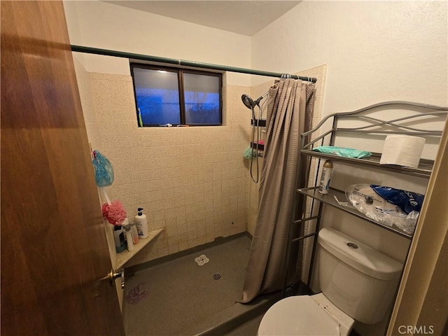 bathroom featuring toilet and a shower with shower curtain