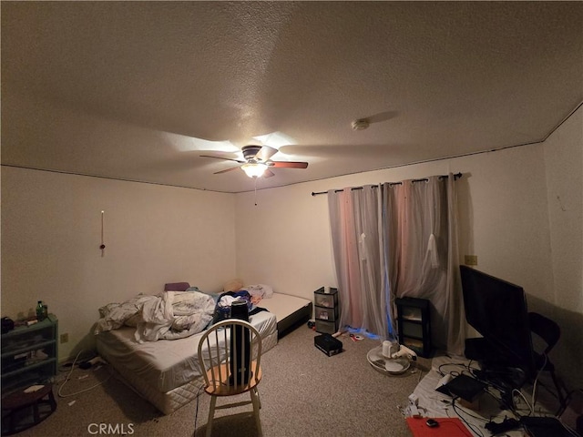 bedroom featuring carpet flooring, a textured ceiling, and ceiling fan