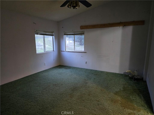 carpeted spare room with ceiling fan and lofted ceiling