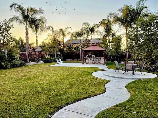 surrounding community featuring a gazebo, a patio area, and a lawn