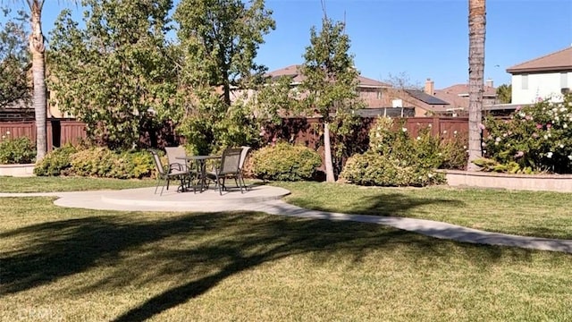 view of home's community with a yard and a patio area