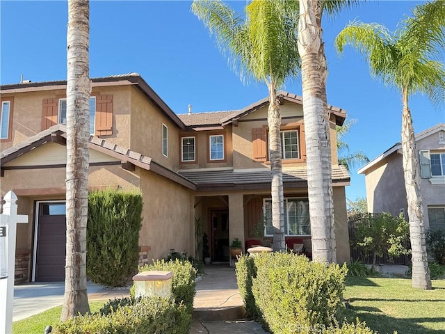 view of front of home featuring a front yard and a garage