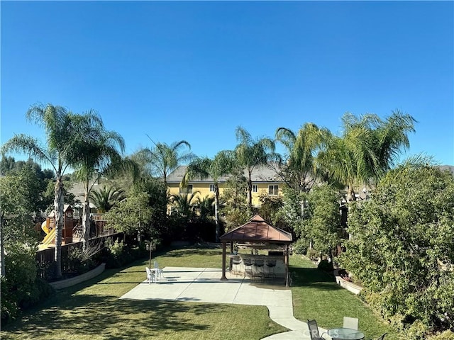 view of home's community featuring a gazebo, a patio area, and a lawn