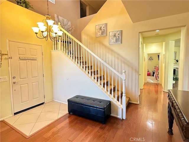 foyer entrance featuring hardwood / wood-style floors and a chandelier