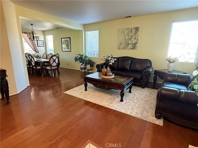 living room with an inviting chandelier and hardwood / wood-style floors