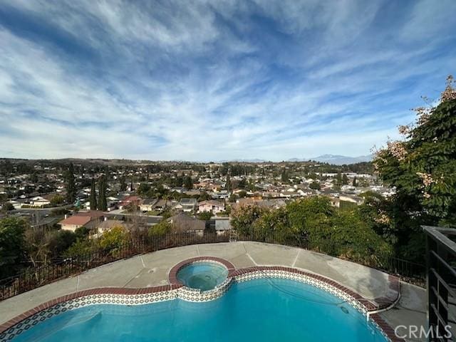 view of swimming pool with an in ground hot tub