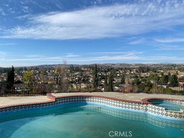 view of pool featuring an in ground hot tub