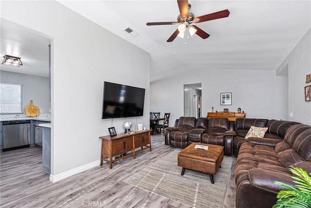 living room featuring lofted ceiling, ceiling fan, and light wood-type flooring