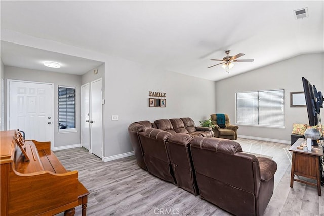 living room with light wood-type flooring, vaulted ceiling, and ceiling fan