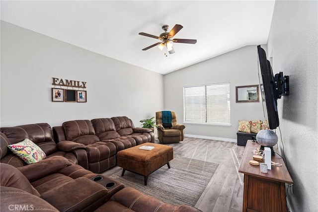 living room with ceiling fan, lofted ceiling, and light hardwood / wood-style flooring