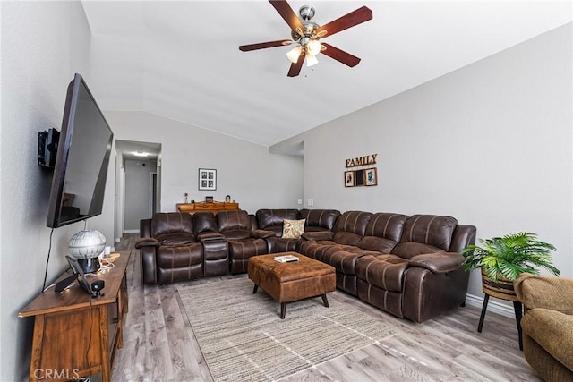 living room featuring hardwood / wood-style flooring, ceiling fan, and vaulted ceiling