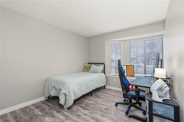 bedroom with wood-type flooring