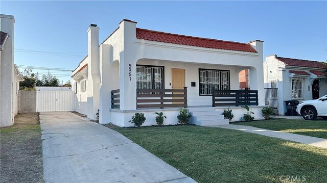 view of front of home with a front yard and a porch