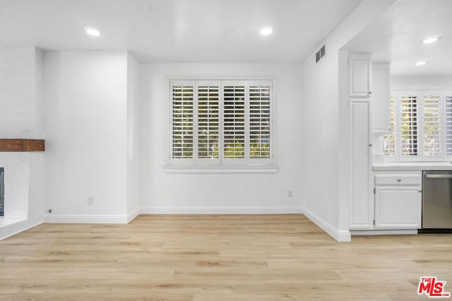 unfurnished dining area featuring a wealth of natural light and light hardwood / wood-style flooring