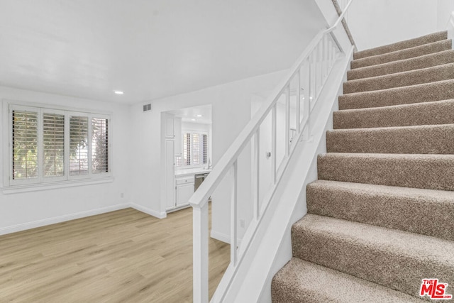 stairway featuring hardwood / wood-style floors