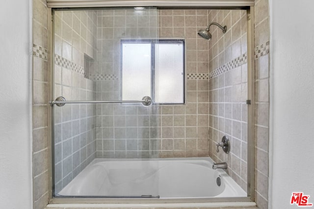 bathroom with shower / bath combination with glass door