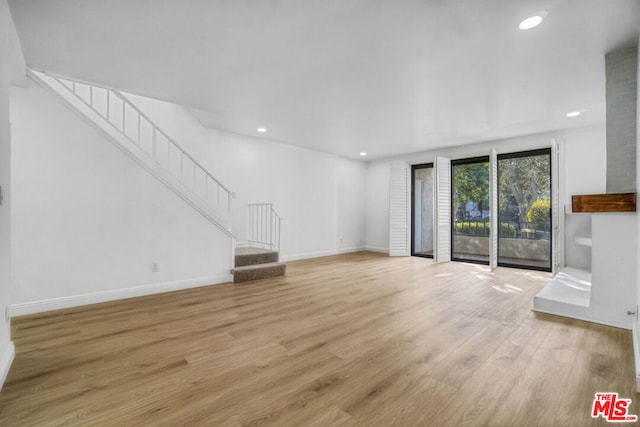 unfurnished living room with light wood-type flooring