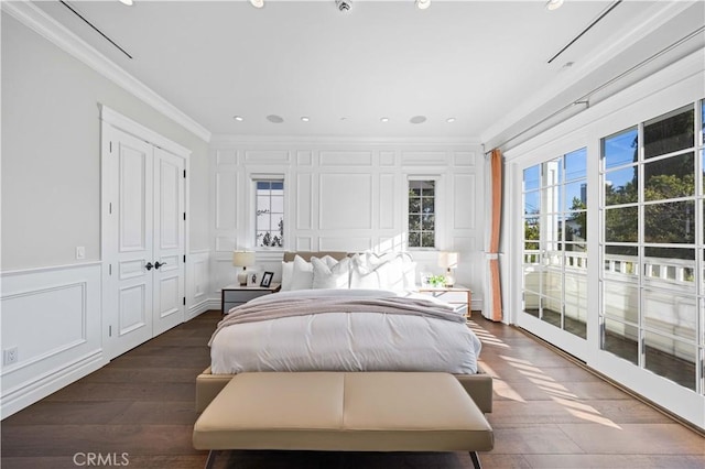 bedroom with access to exterior, dark hardwood / wood-style floors, and ornamental molding