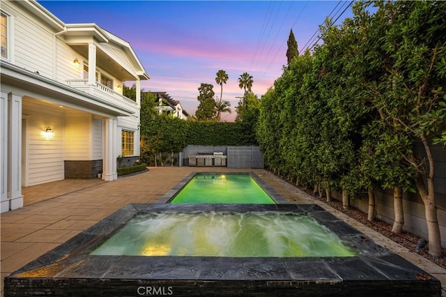 view of pool at dusk