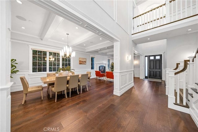 dining space with beamed ceiling and dark hardwood / wood-style flooring