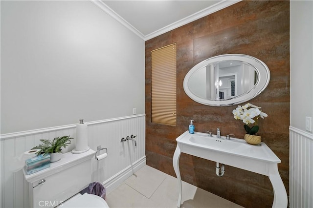 bathroom with tile patterned floors, toilet, and crown molding