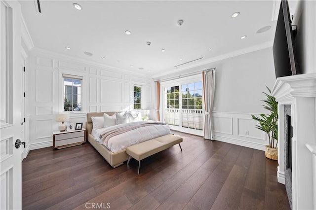 bedroom with access to exterior, dark hardwood / wood-style floors, and crown molding