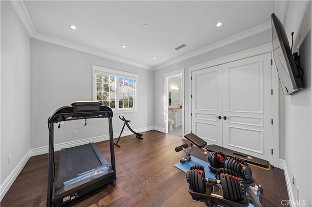 exercise room with dark hardwood / wood-style floors and crown molding