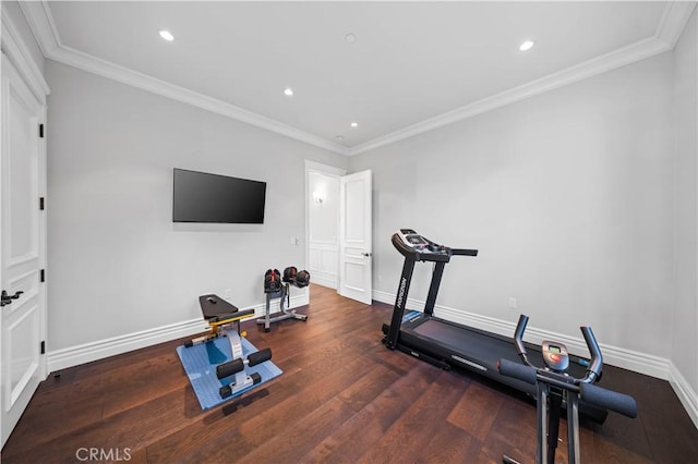 workout room featuring dark hardwood / wood-style flooring and crown molding