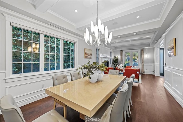 dining space featuring beamed ceiling, dark hardwood / wood-style floors, ornamental molding, and an inviting chandelier