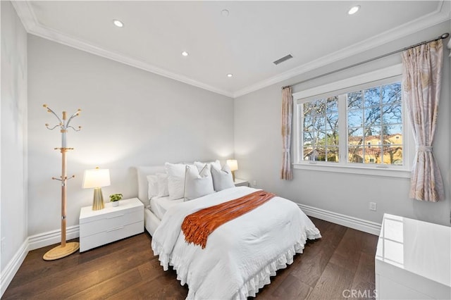 bedroom with dark hardwood / wood-style flooring and ornamental molding