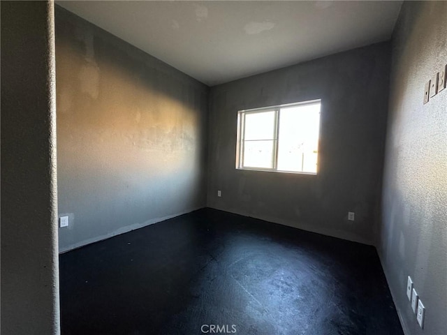 unfurnished room featuring concrete flooring