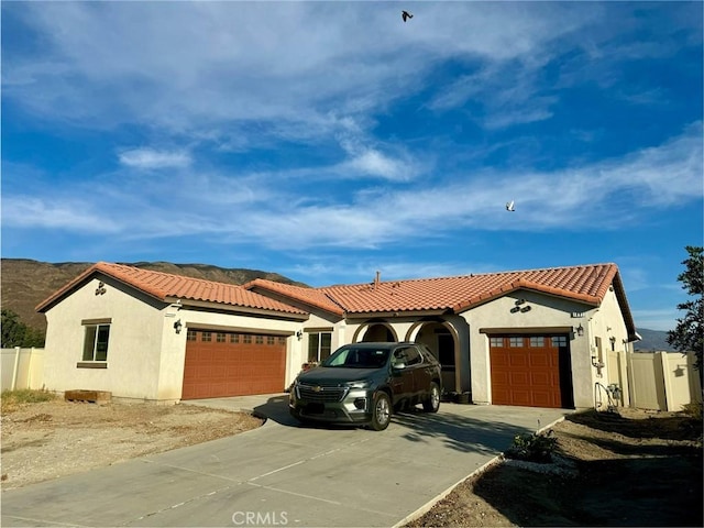 mediterranean / spanish house with a garage