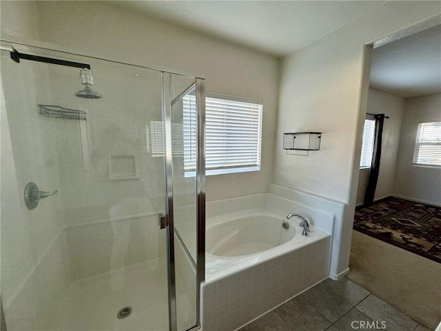 bathroom with tile patterned flooring and independent shower and bath